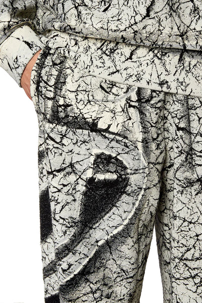 Track pants with cracked coating